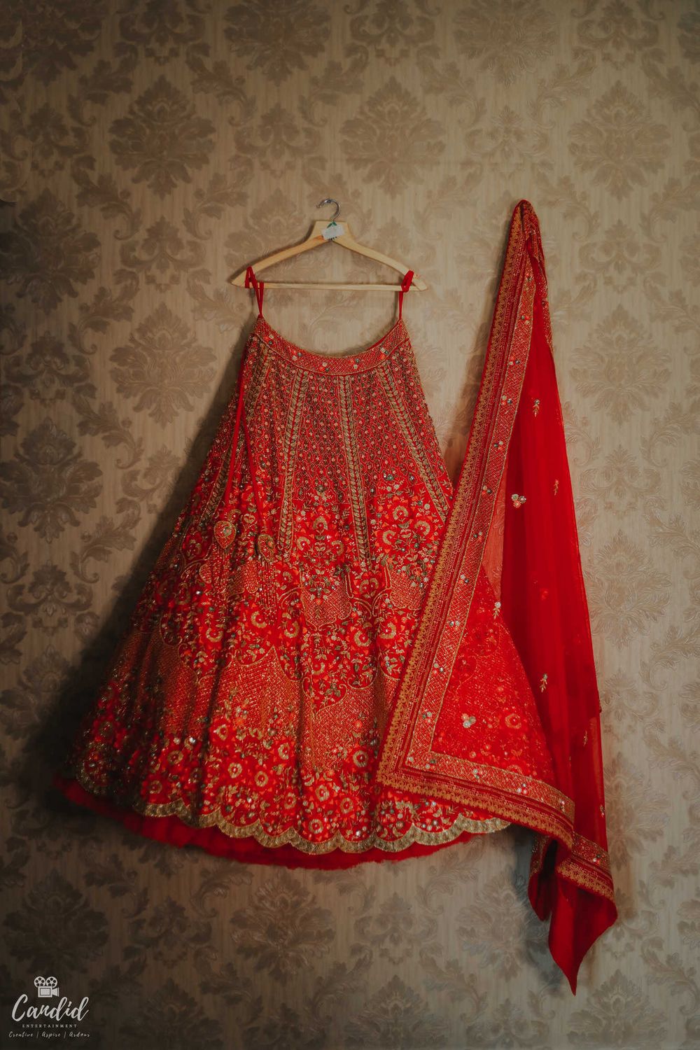 Photo of red bridal lehenga on hanger shot