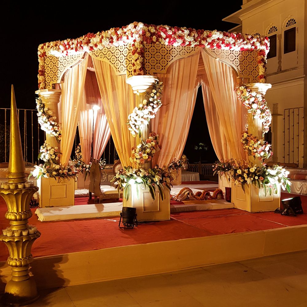Photo of A beautifully draped mandap with floral arrangements