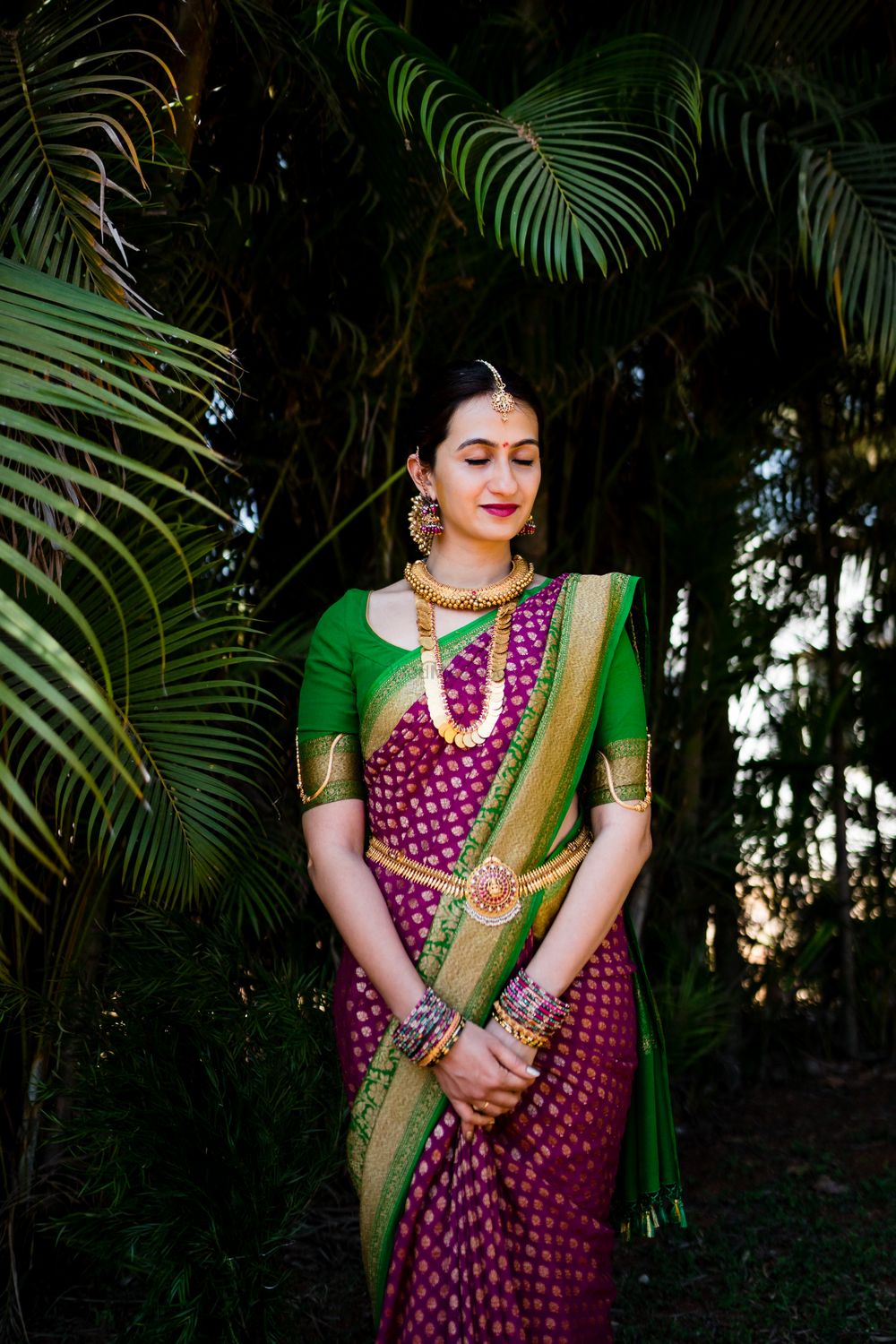Photo of A south Indian bride dressed in purple and green saree
