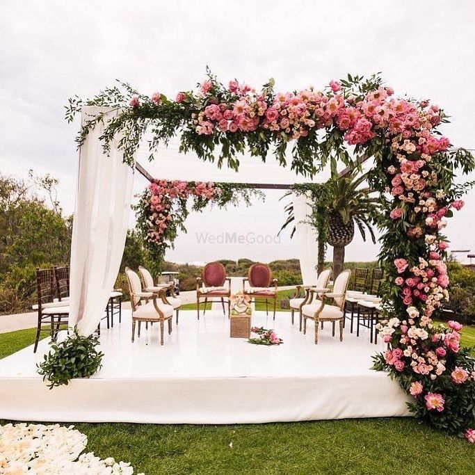 Photo of A gorgeous pink floral mandap by the seaside.