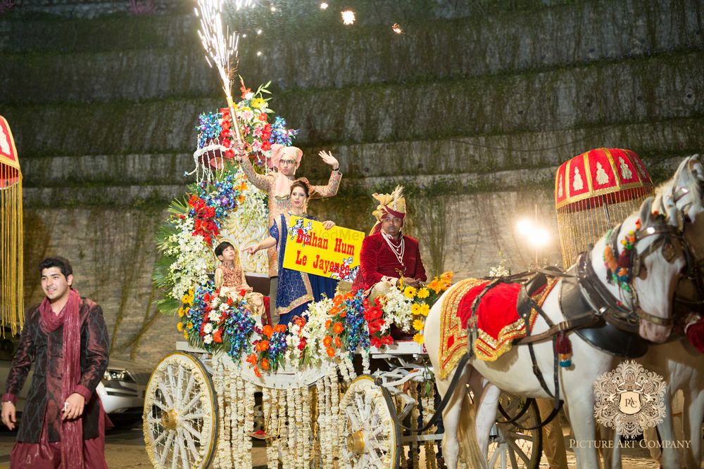 Photo of Dramatic Groom Entry on Carriage with Fireworks