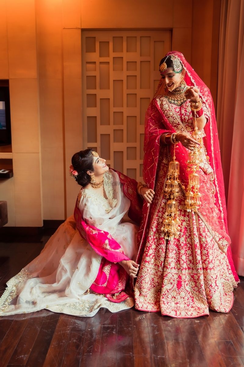Photo of Bride with her sister, getting ready for her wedding