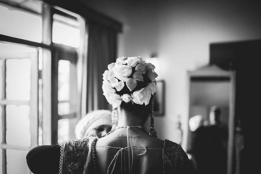Photo of unique bridal bun with white flowers