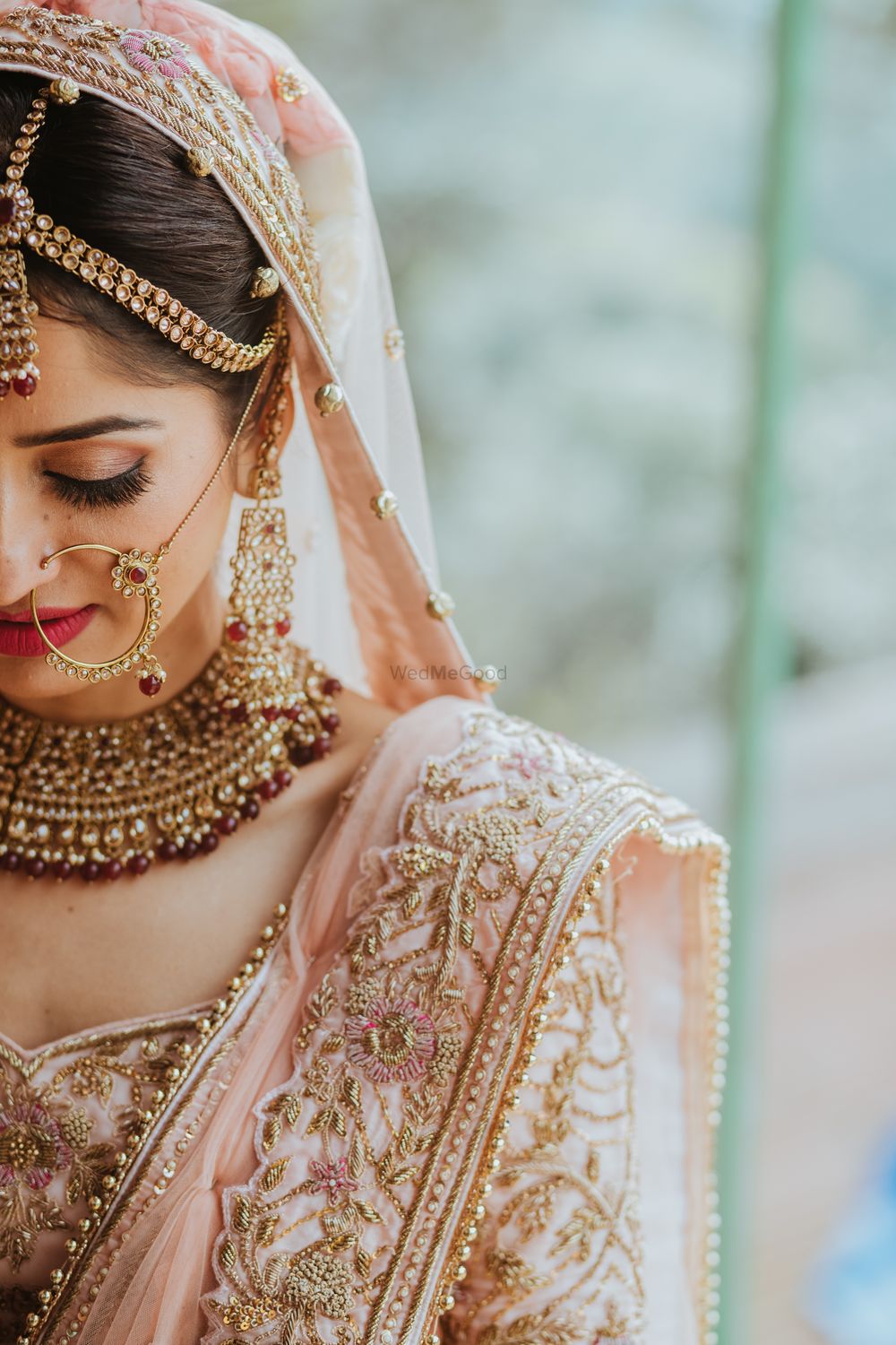 Photo of bridal close up shot in pastel lehenga and contrasting jewellery