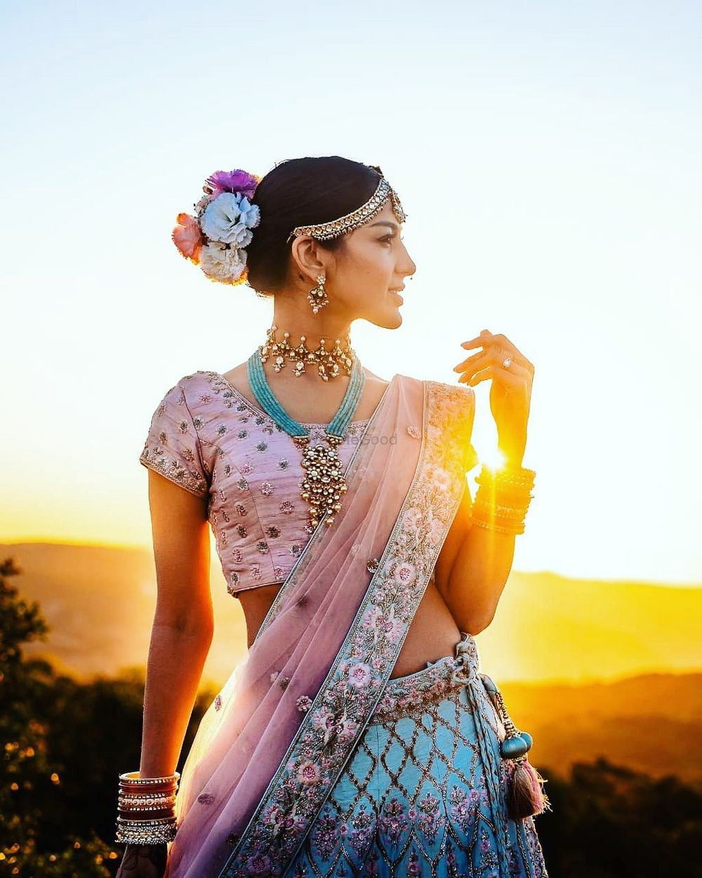 Photo of Candid shot of a bride dressed in a pink and blue lehenga.