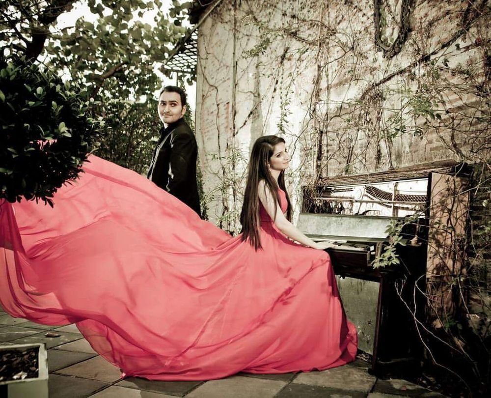 Photo of Romantic Pre Wedding Shoot with Piano and Flowing Gown