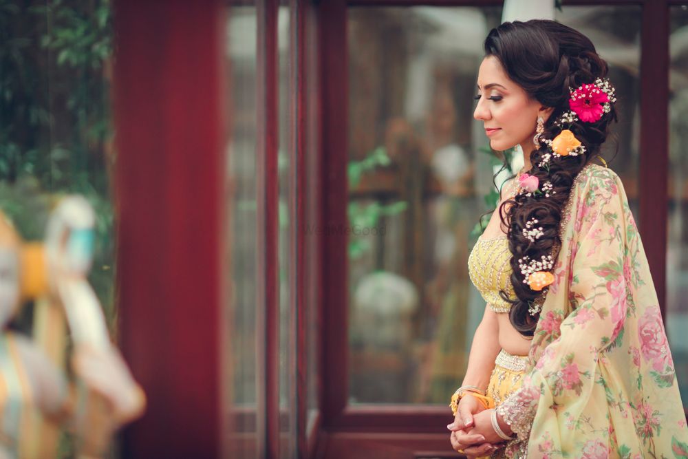 Photo of pretty floral side braid for bride for a mehendi hairstyle