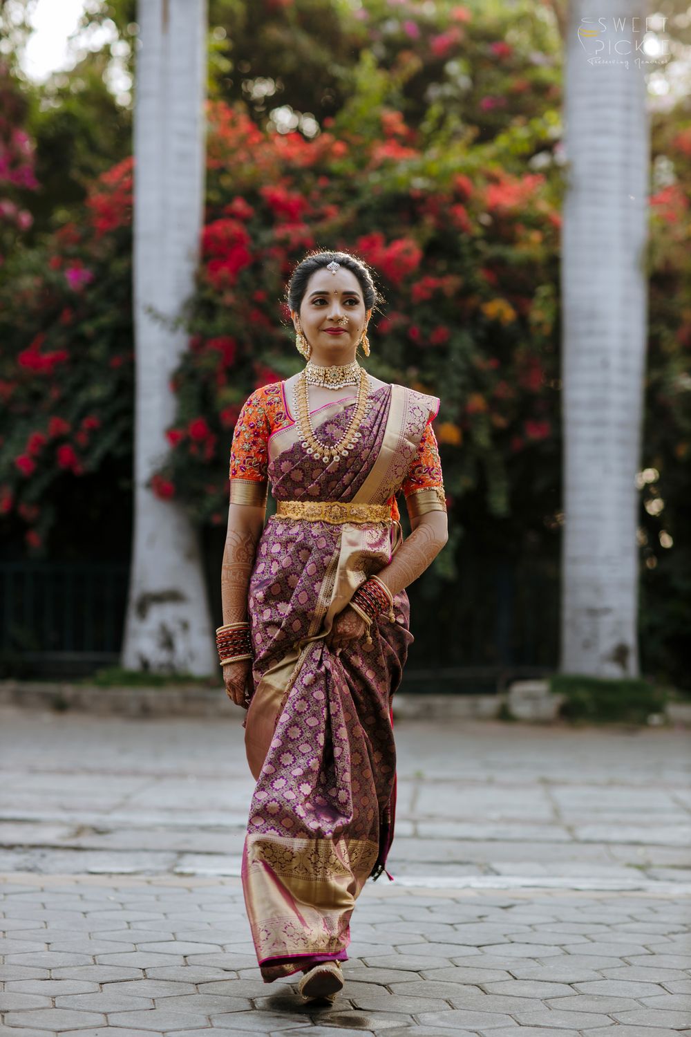 Photo of unique south indian bridal look in maroon saree