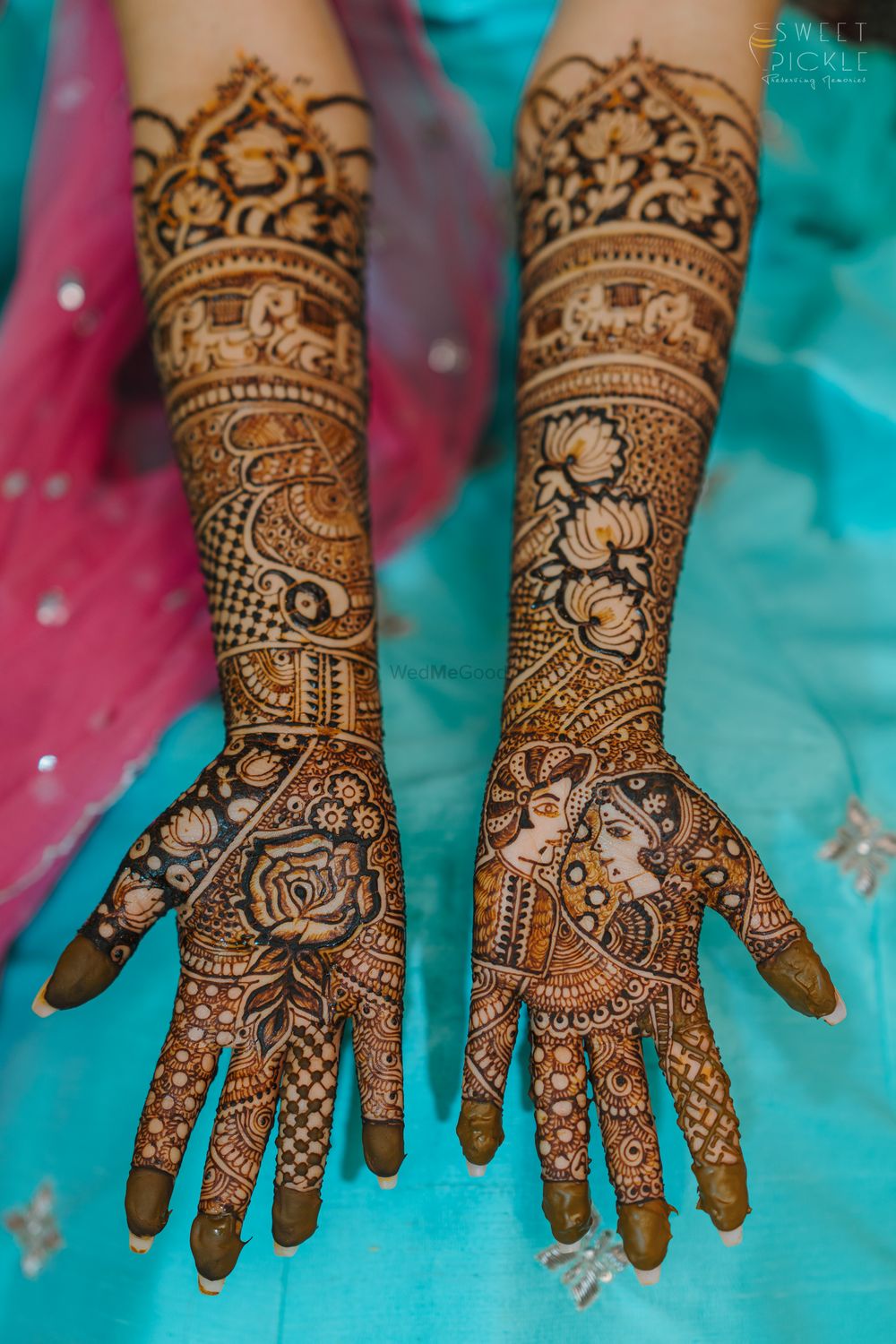 Photo of unique mehendi with bride and groom portraits
