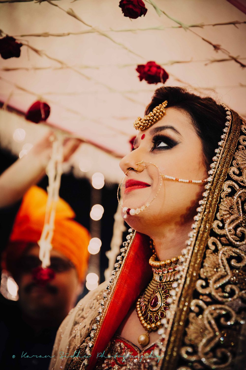 Photo of Bride Looking Up at Phoolon Ki Chadar Portrait