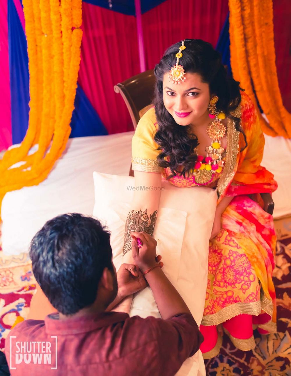 Photo of Bride Getting Mehendi with Gota and pompom Jewellery