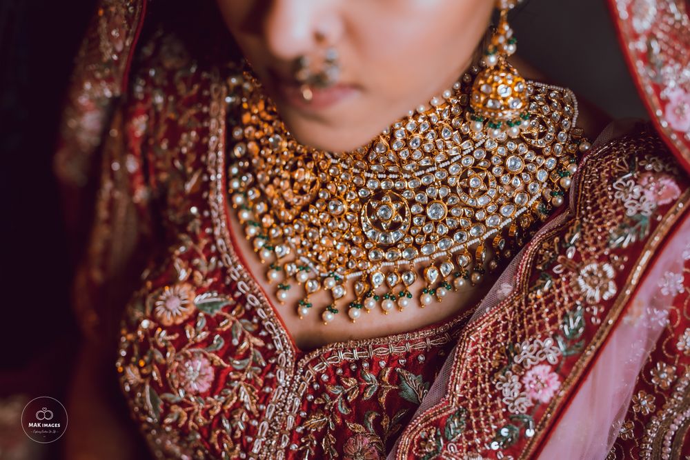Photo of Uncut polki necklace paired with a red lehenga.