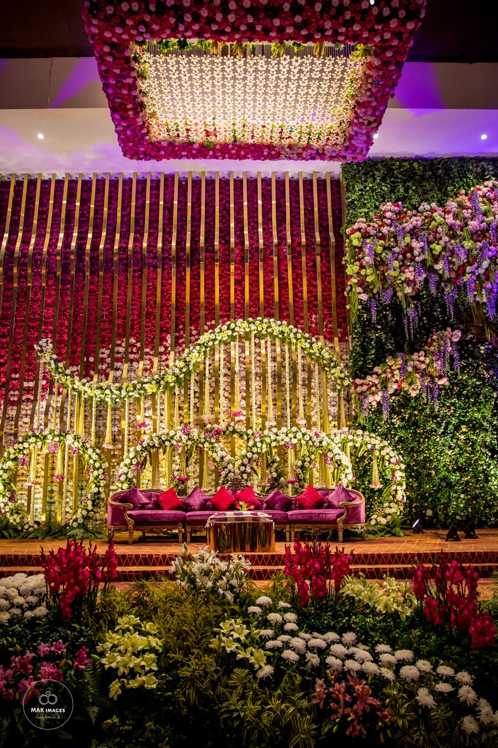 Photo of Wedding stage with a floral backdrop.