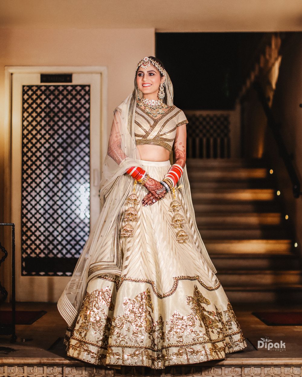 Photo of Bride in a beautiful beige and gold lehenga.
