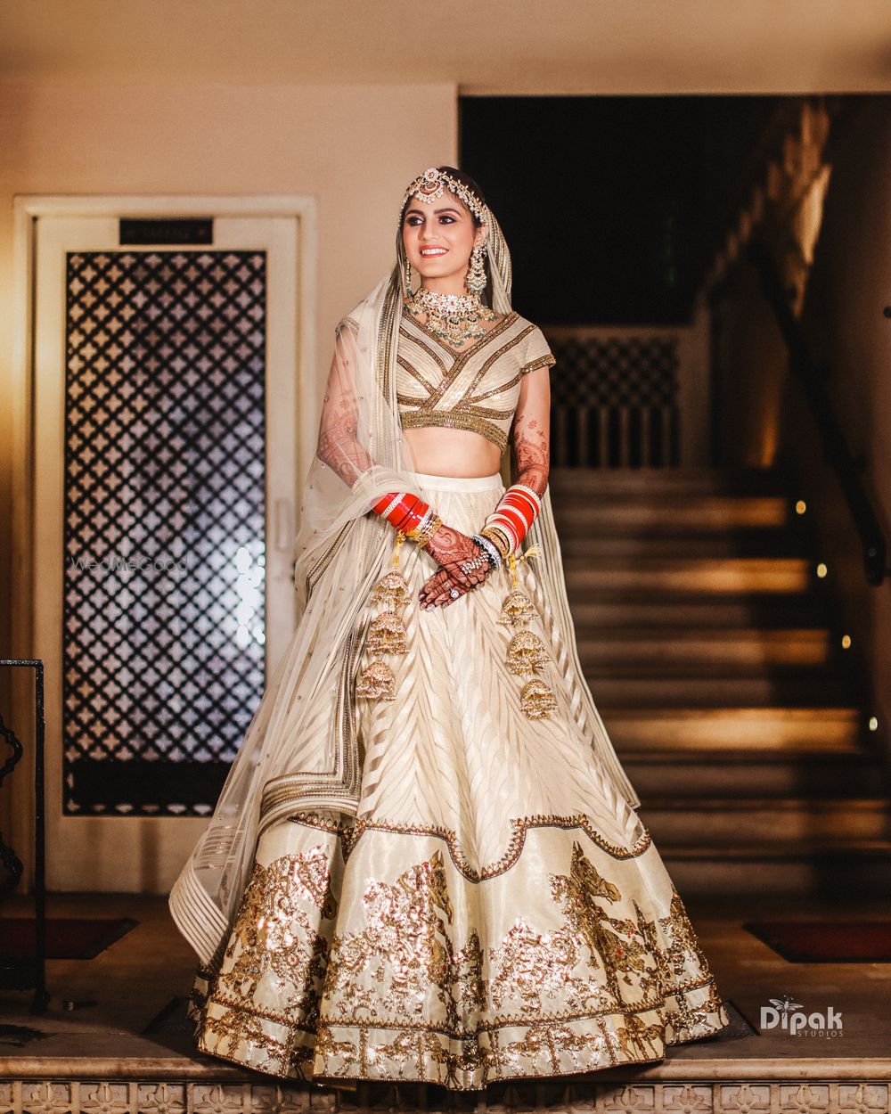 Photo of Bride in a beautiful beige and gold lehenga.