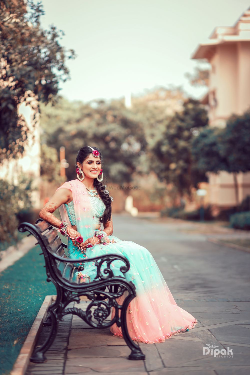 Photo of Bride wearing a dual-toned lehenga with floral jewellery.