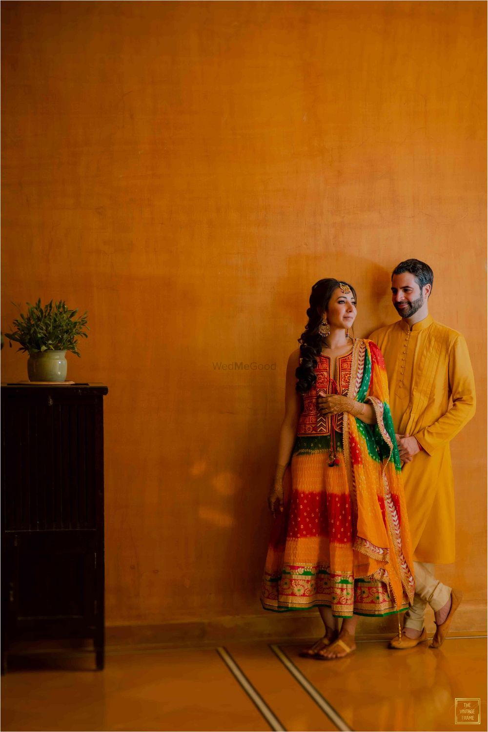 Photo of A candid shot of a couple dressed in vibrant outfits.