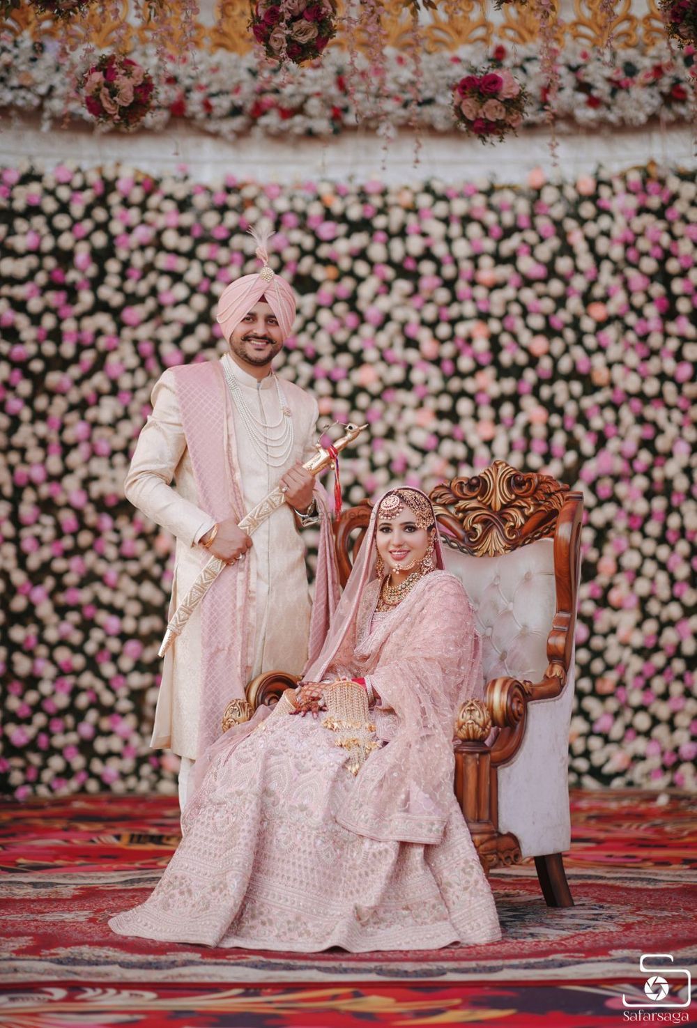Photo of Brid and Groom color-coordinating in pink outfits.