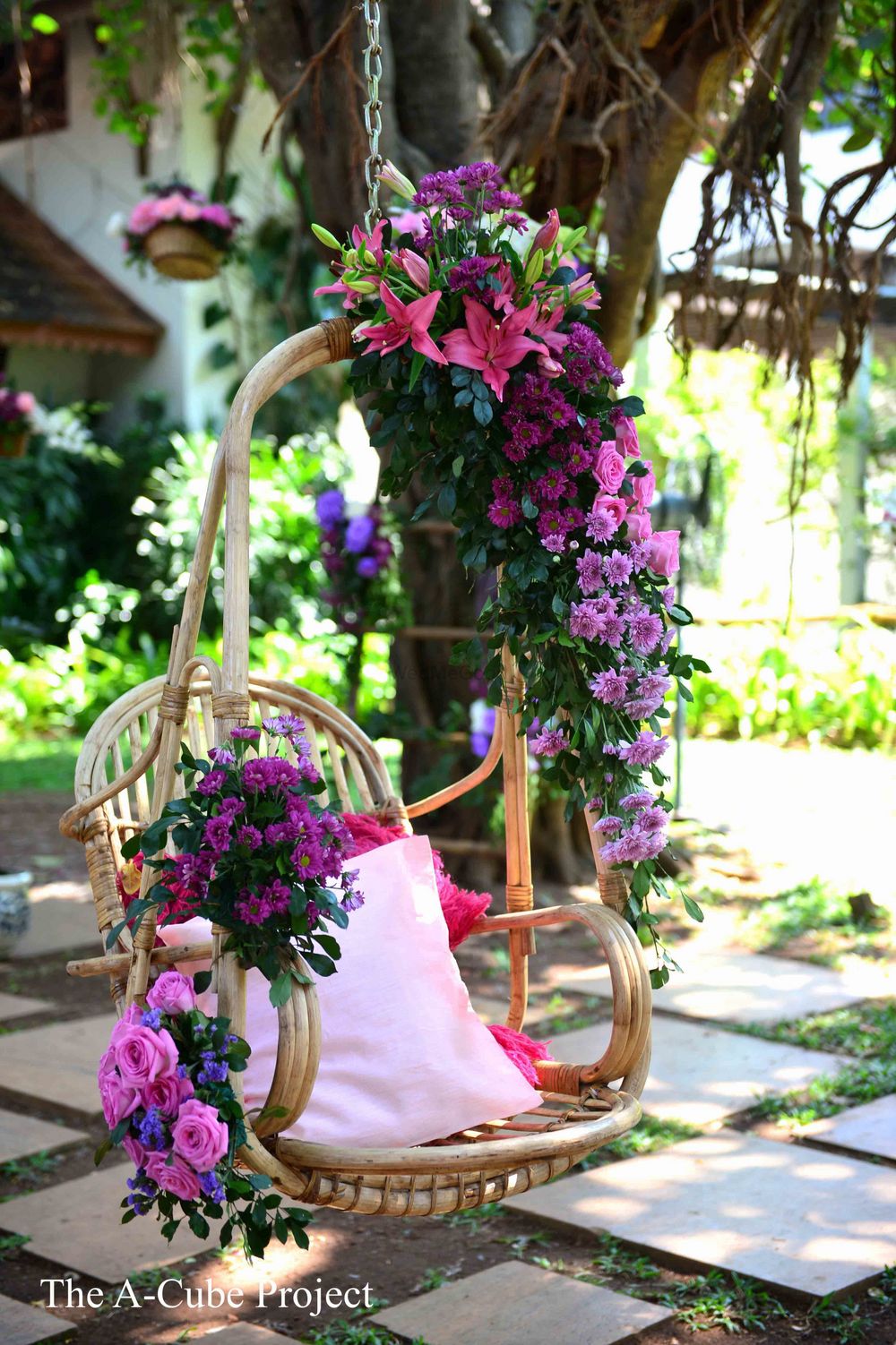 Photo of Jhoola seating with purple flowers.