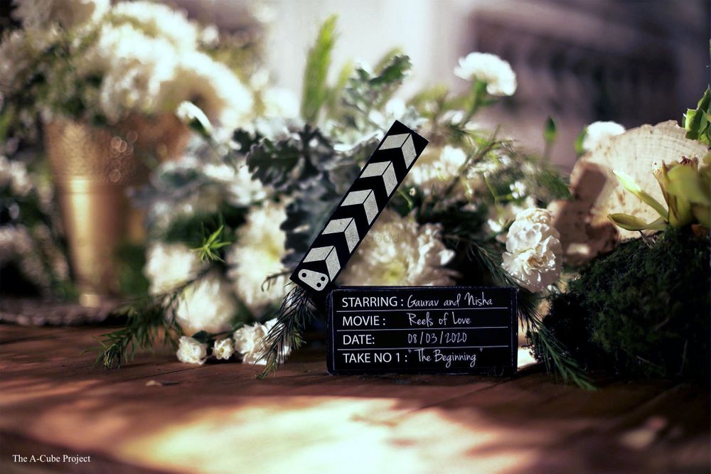 Photo of Clapper boards and flowers used as a table centerpiece.