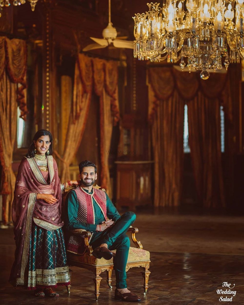 Photo of matching mehendi bride and groom outfits in dark green and red