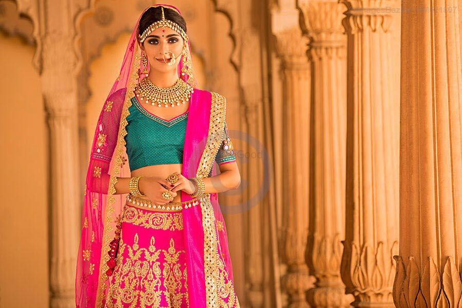 Photo of Bright Pink and Gold Lehenga with Teal Blouse