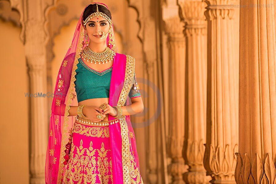 Photo of Bright Pink and Gold Lehenga with Teal Blouse