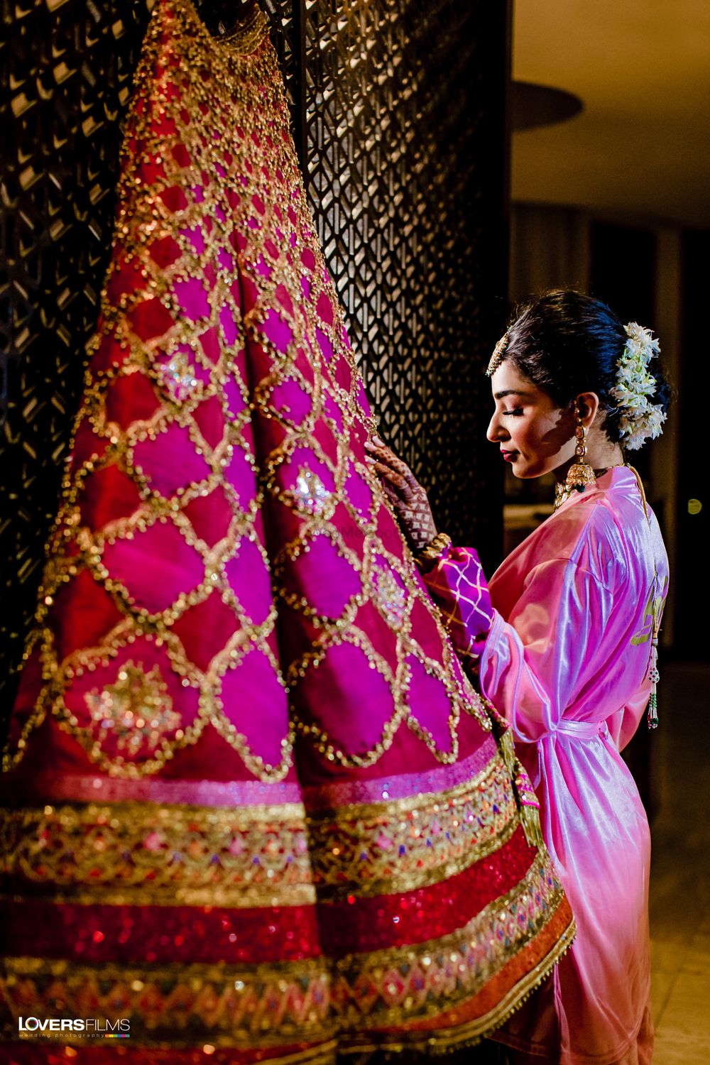 Photo of bride with her lehenga in her robe