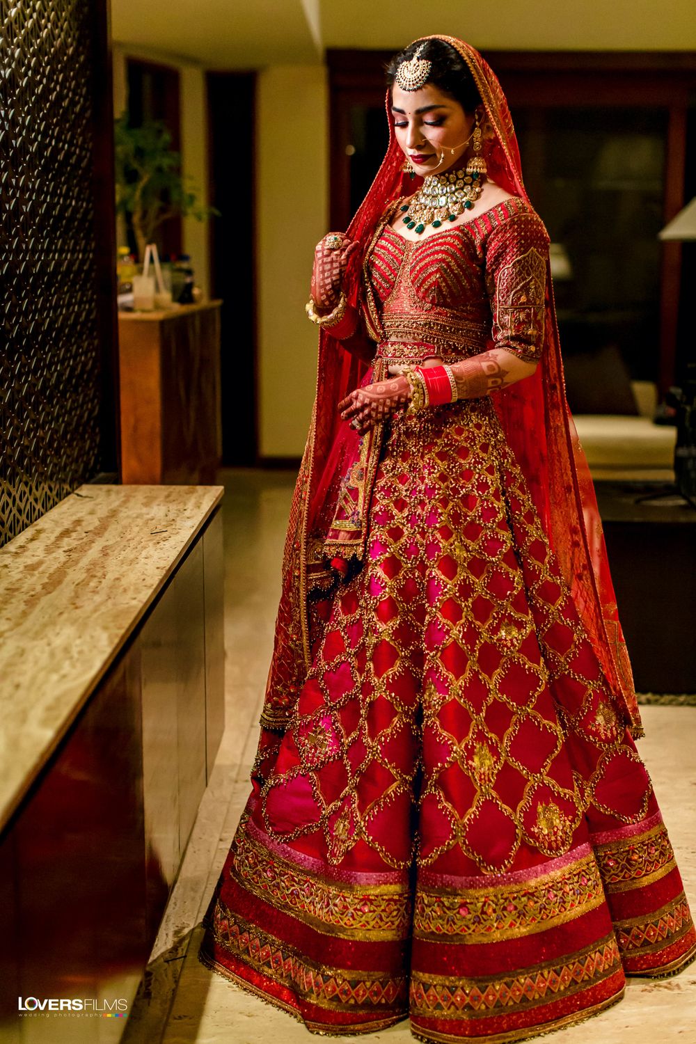 Photo of red modern bridal lehenga with gold work