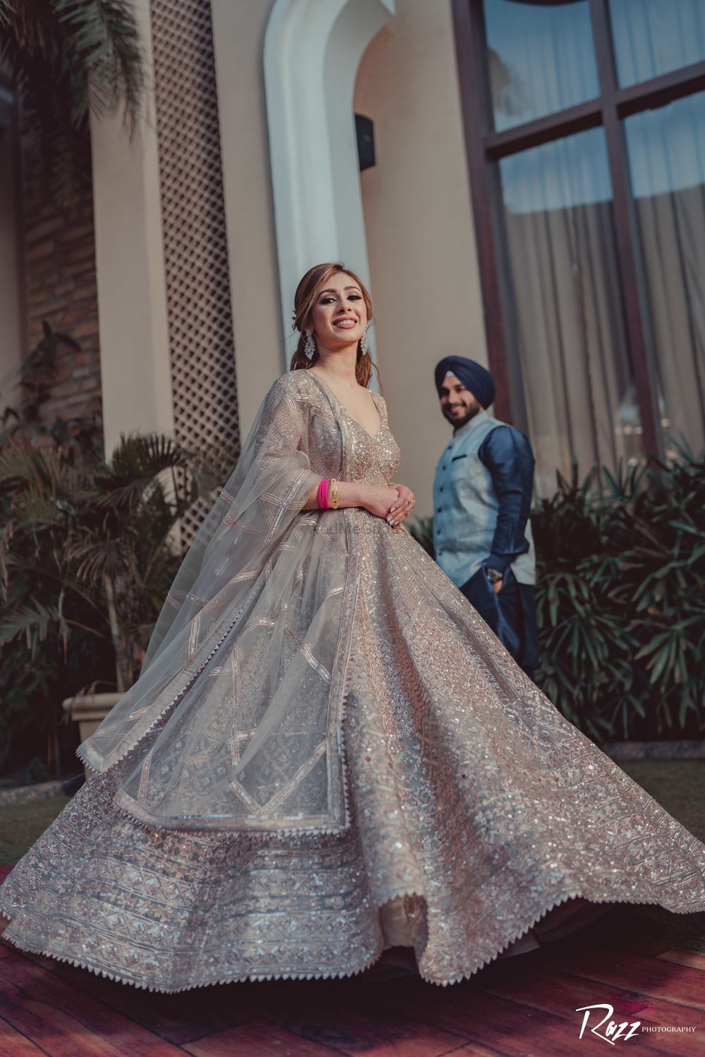 Photo of Bride twirling in silver lehenga.