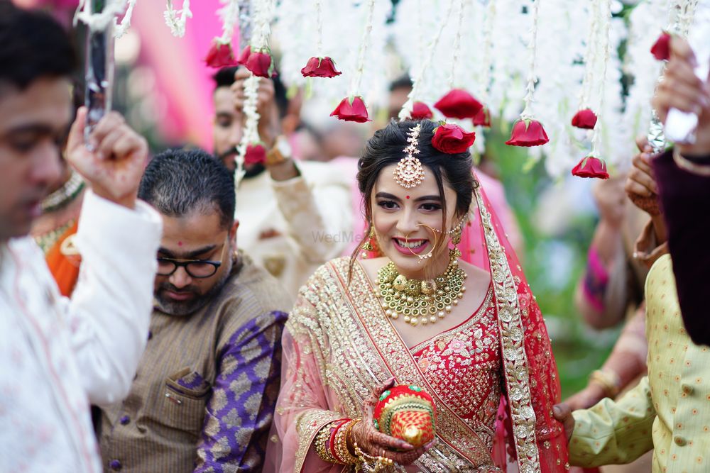 Photo of Bride entering under a phoolon ki chaadar.