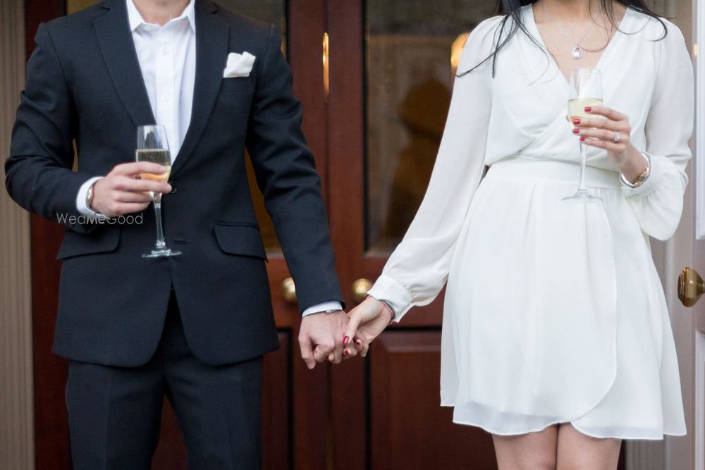 Photo of pre wedding shoot engagement session with wine glass