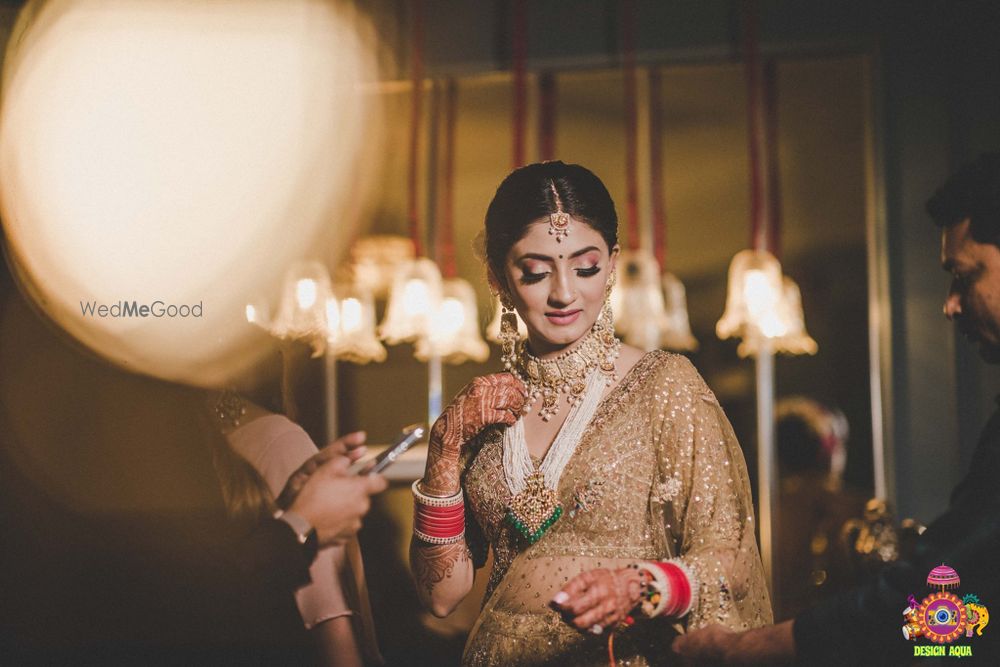 Photo of bridal portrait in gold lehenga with rani haar