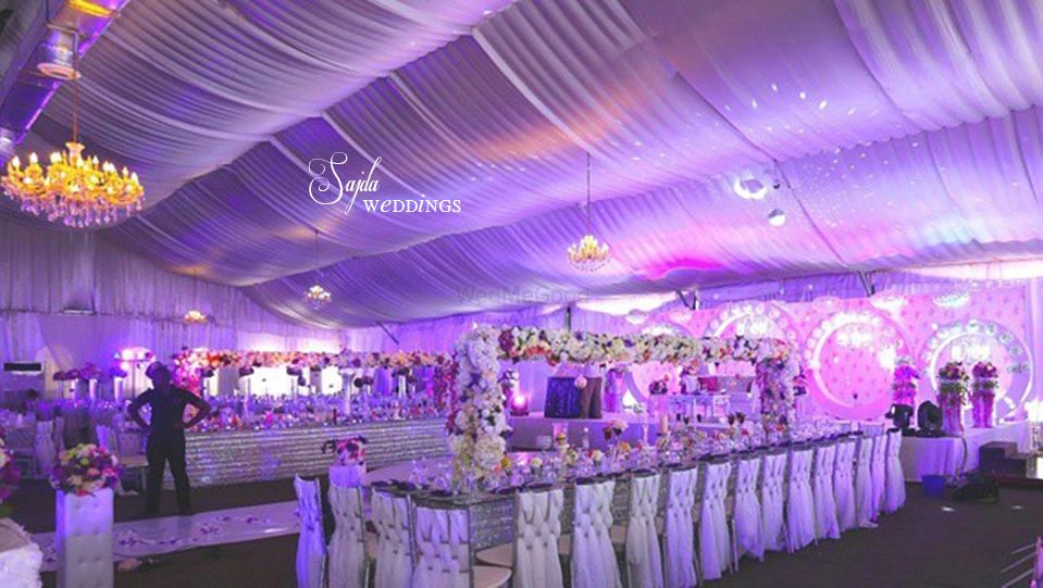 Photo of white themed engagement with draped ceiling