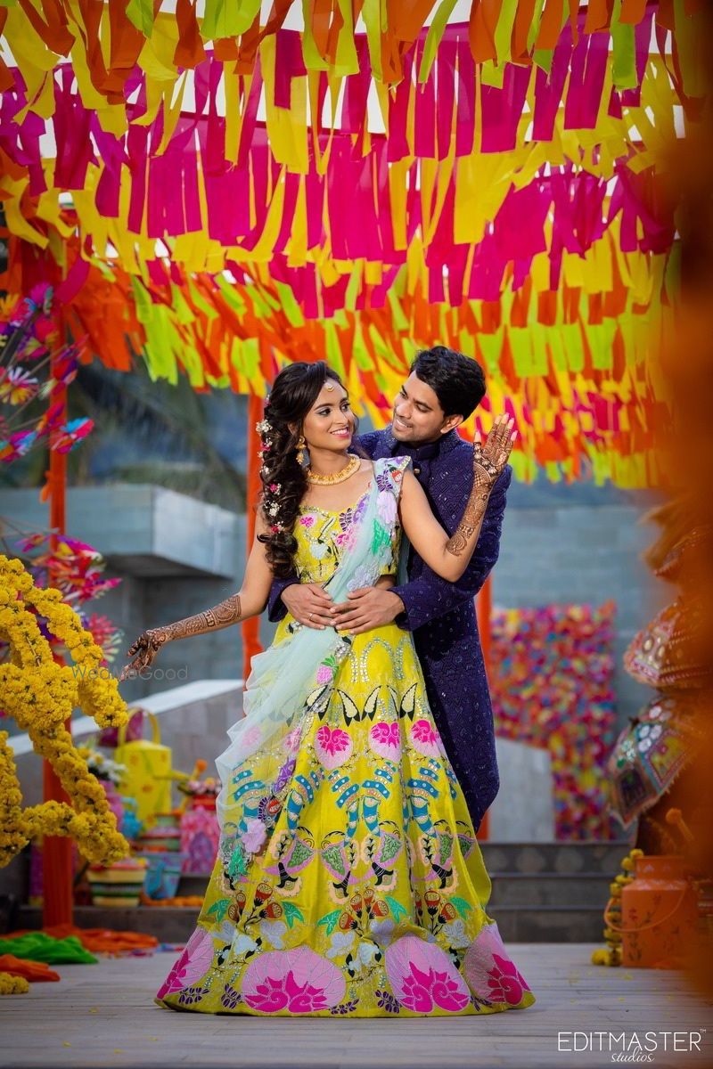 Photo of Bride and groom posing on mehendi ceremony.