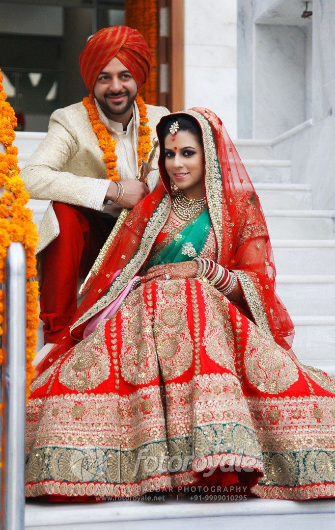 Photo of Bright Red Bridal Lehenga with Teal Border and Dupatta