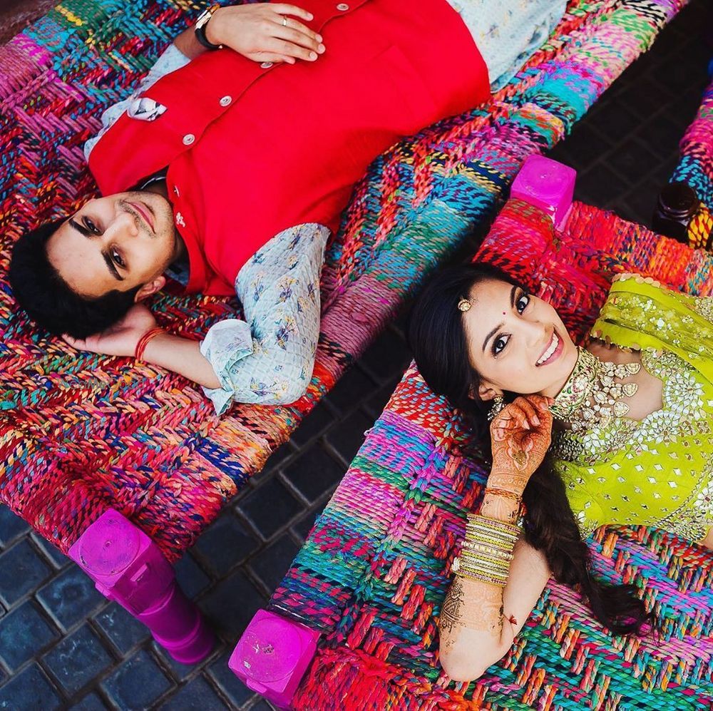 Photo of Couple lying on cots and posing.