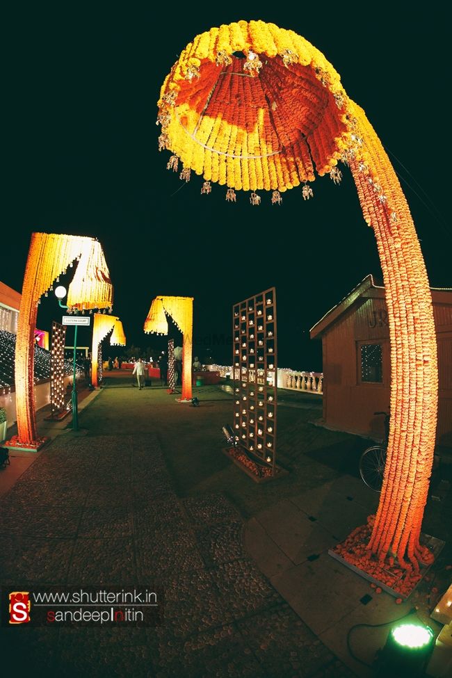 Photo of Orange Entrance Decor with Genda Phool Umbrellas
