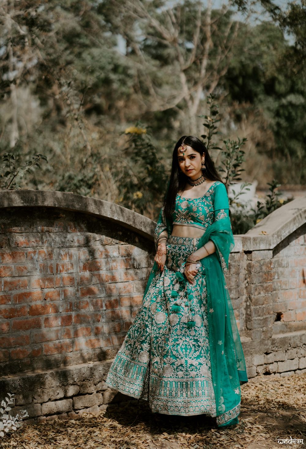 Photo of Bride wearing teal green lehenga.