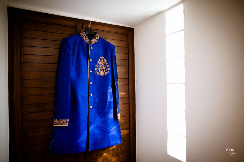 Photo of Royal Blue Sherwani on Hanger with Gold Thread Work