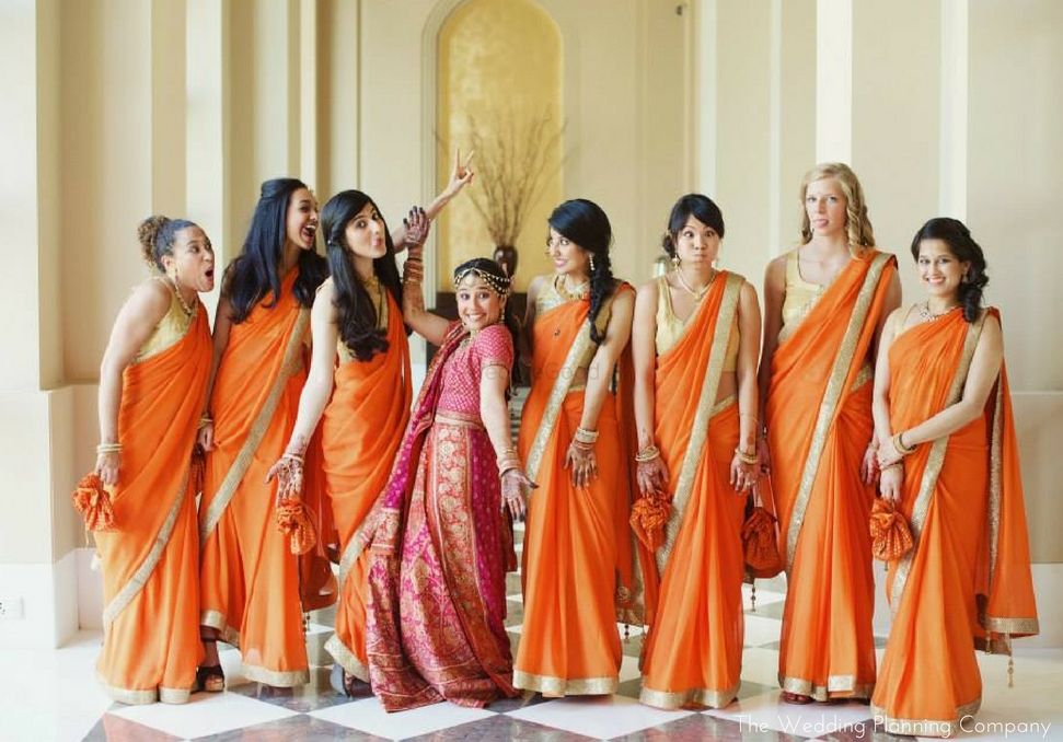 Photo of Matching Bridesmaids in Orange Sarees Fun Photo