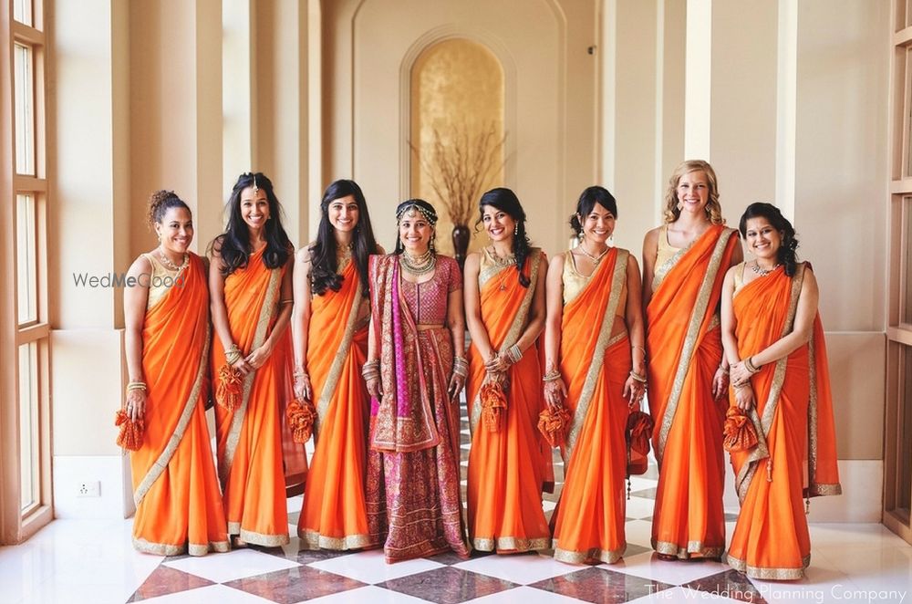 Photo of Bride with Matching Bridesmaids in Orange Sarees