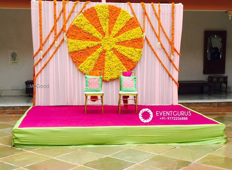 Photo of Colourful Mehendi Decor with Genda Phool Stage Wall