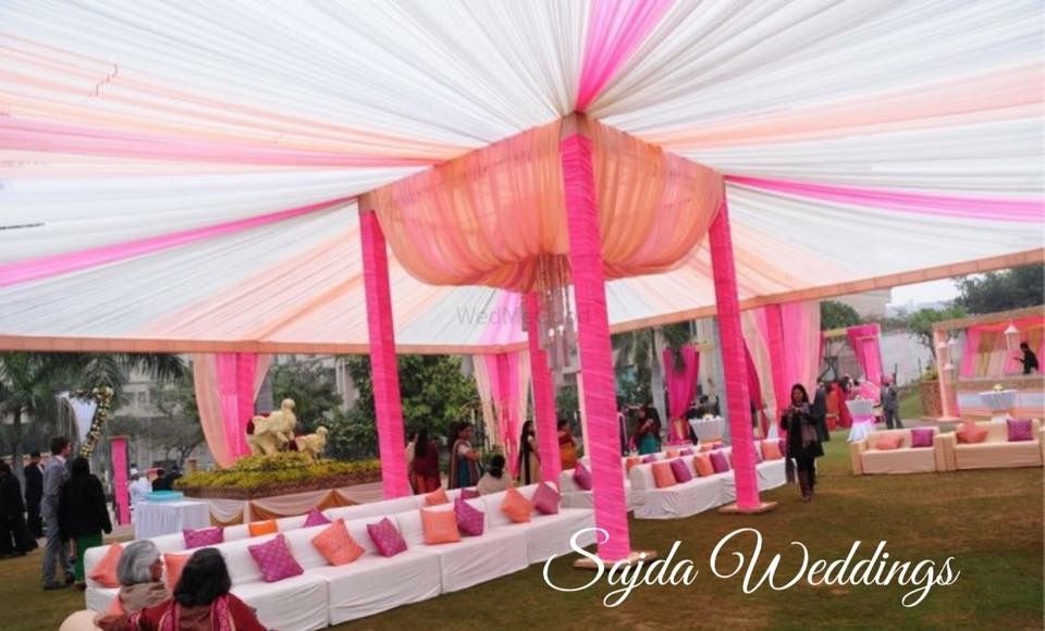 Photo of outdoor morning wedding decor color theme of peach pink