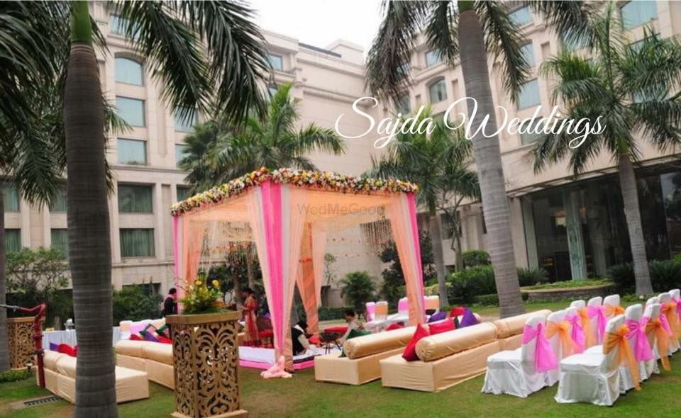 Photo of peach pink and white mandap outdoor
