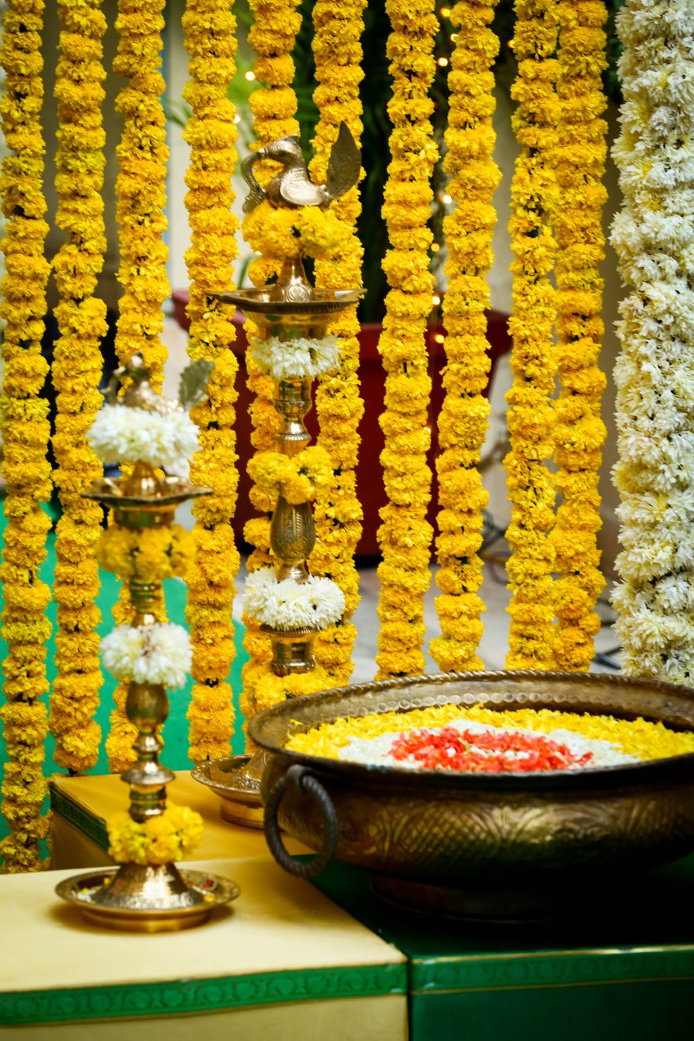 Photo of south Indian telegu wedding decor traditional mehendi decor with genda flower strings