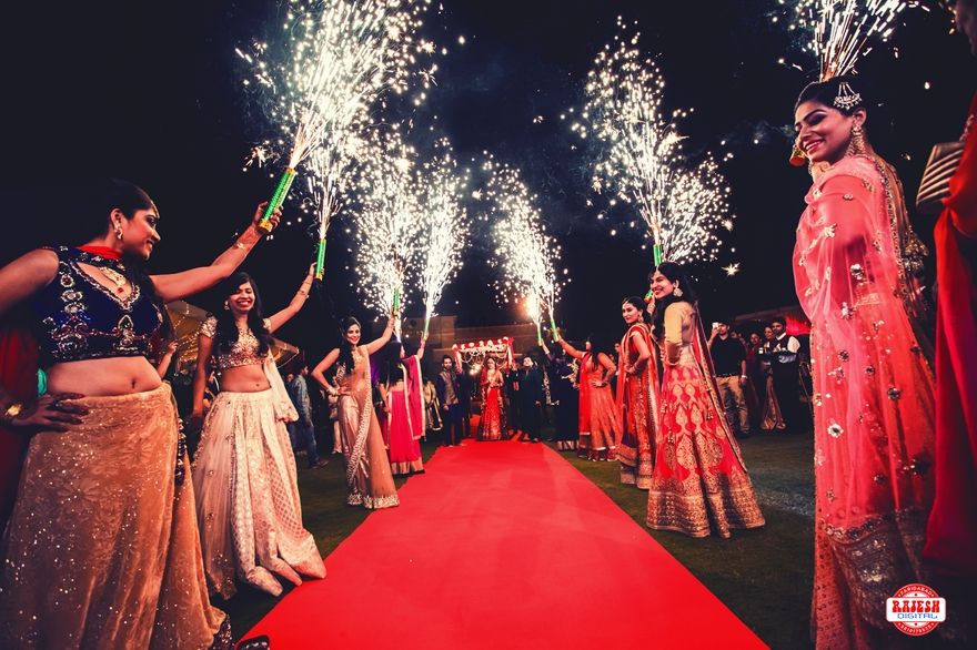 Photo of Guests Holding Light Pyro for Bride and Groom Entrance
