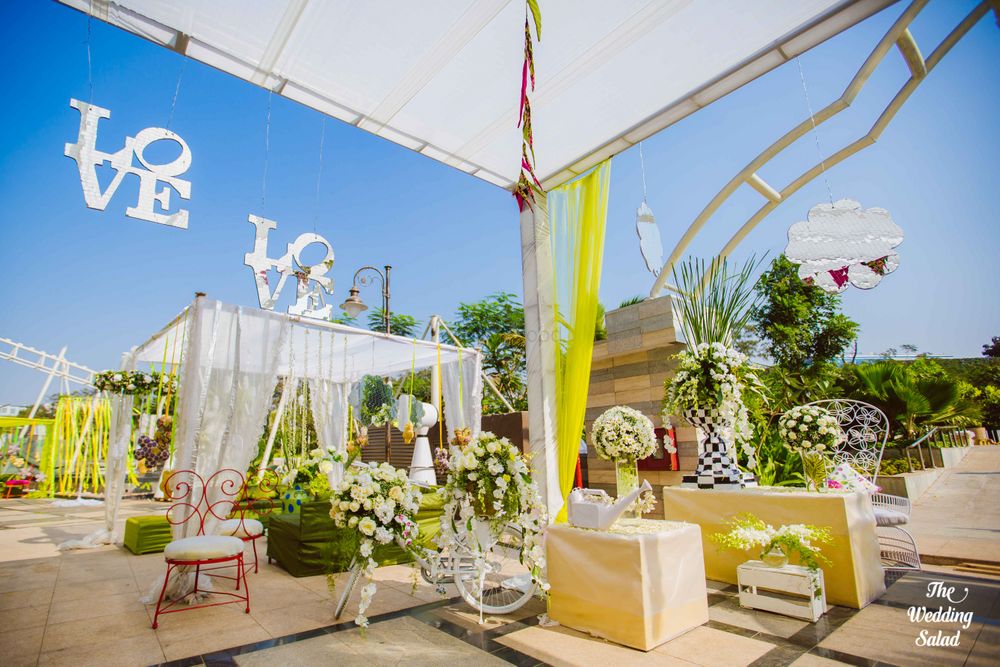 Photo of Summery Decor with Monograms and Floral Arrangements