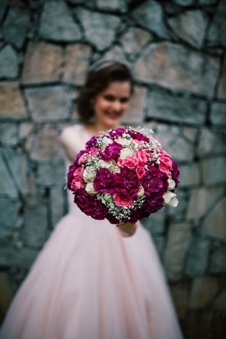 Photo of Bride with purple and pink bouquet