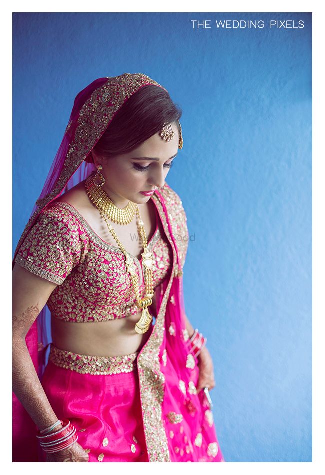 Photo of Bright Pink Bridal Lehenga with Gold Sequin Work